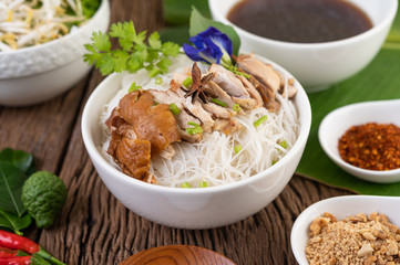 Chicken noodle in a bowl with side dishes, Thai food