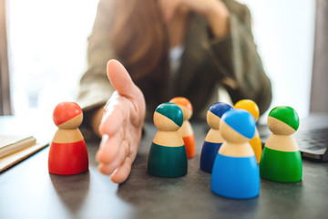 Concept image of a business woman separate one wooden people from a group