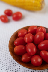 Tomatoes and corn placed on a white cloth