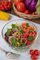 Fruit and vegetable salad in a glass cup on a white ground