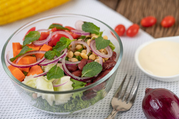 Fruit and vegetable salad in a glass cup on a white ground