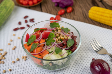 Fruit and vegetable salad in a glass cup on a white ground