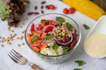 Fruit and vegetable salad in a glass cup on a white ground