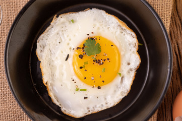 Fried eggs in a frying pan and raw eggs, organic food for good health, high in protein