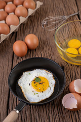Fried eggs in a frying pan and raw eggs, organic food for good health, high in protein