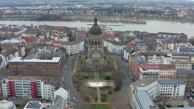 Aerial panorama fly away cinematic shot of the christus church in mainz with the river rhine in the background 25p