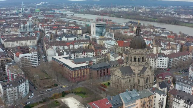 Aerial panorama rotating cinematic shot of Mainz and the christus church with the river rhine in the background 30p