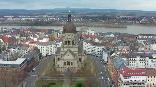 Aerial cinematic shot of the christus church in mainz with the river rhine in the background 25p