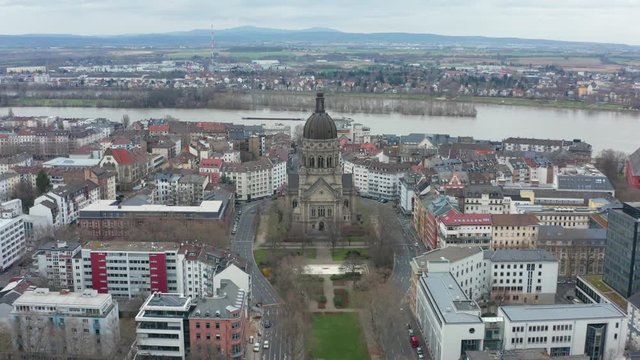 Aerial panorama fly over cinematic shot of the christus church in mainz with the river rhine in the background 25p