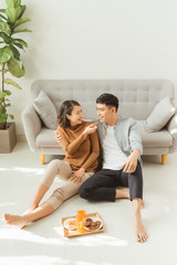 Young asian couple relaxing at home