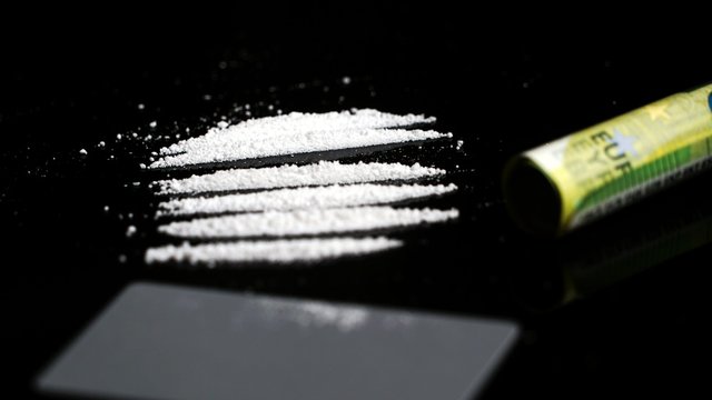 Cocaine lines on black background