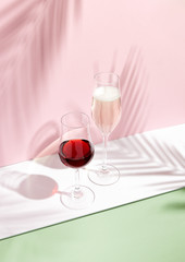 Champagne and red wine on creative background
