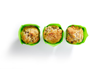 Three Muffins or Cupcakes in Green Paper Isolated
