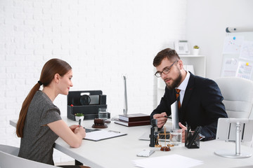 Male lawyer working with client in office
