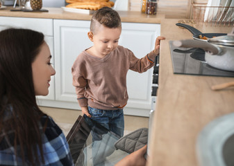 Mother with son cooking together in kitchen