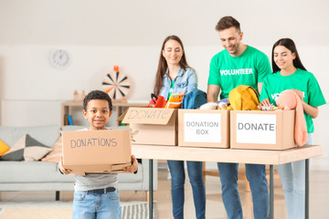 Fototapeta na wymiar Volunteers with donations at orphan home