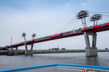 Fototapeta na wymiar Russia, Blagoveshchensk, July 2019: Bridge on the Amur river from Blagoveshchensk to the Chinese city of Heihe in summer