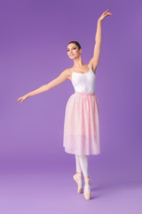Beautiful young ballerina on color background