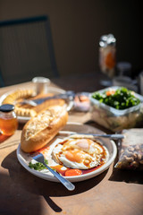 breakfast with Fried eggs, bread, cereals, honey, cereals and vegetables