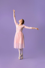 Fototapeta na wymiar Beautiful young ballerina on color background