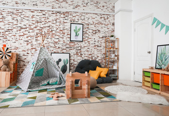 Wooden take-apart playhouse and play tent in interior of children's room