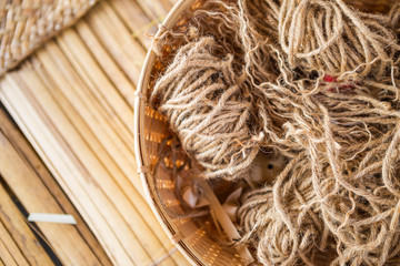 Closeup jute string in bamboo basket, nature textured hessian string