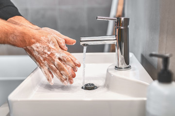 Washing hands with soap and warm water for 20 seconds for corona virus COVID-10 prevention. Work...