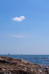 Walk on the sea on a board with a sail.