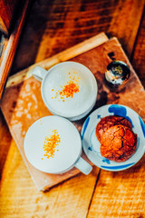 Two Coffee cup of cappuccino and Brownie cookies on the wooden table ,Street coffee, top view.