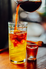 Iced coffee with  fresh honey   or iced americano  In Glass On wood tabel, The drink menu
