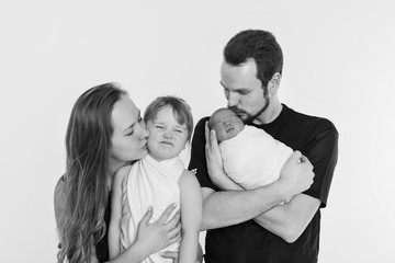 concept of healthy lifestyle, protection of children, shopping - baby in the arms of the mother and father. Woman and man holding a child. Isolated on white background. Copy space. Portrait of faamily