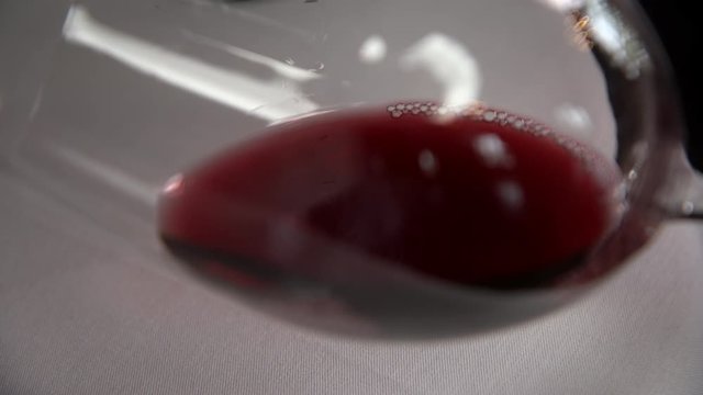 Malbec wine with a sommelier examining its qualities over white in slow motion 4k footage.