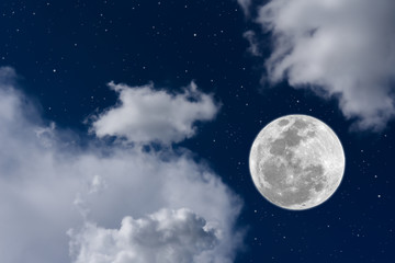 Fototapeta na wymiar Full moon on blue sky between blurred white cloud.