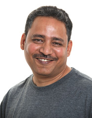 Fototapeta premium An Indian man smiling to camera. Shot against a white background.