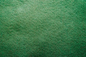 Dark green felt soft rough textile material background texture close up