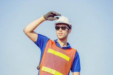 Cheerful shipping company workers working at the harbor, Engineering man looking to the sky