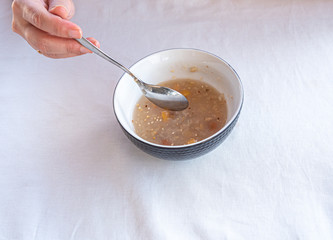 Traditional Turkish dessert ashure or Noah's Pudding with spoon on the table.