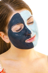 Girl with black white mud mask on face