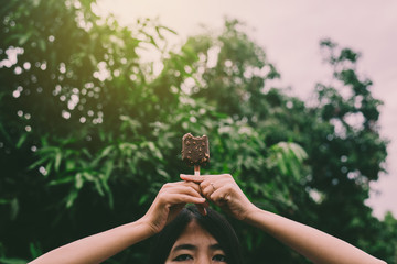 Woman hands holding chocolate ice cream waffle cone calories at outdoor