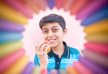 a little boy eating orange