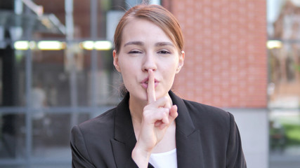 Silence Please, Finger on Lips by Young Businesswoman