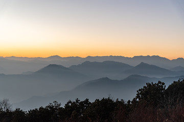 Stacked mountain ridges seen during golden hour of sunset from Poonhill Ghorepani Nepal