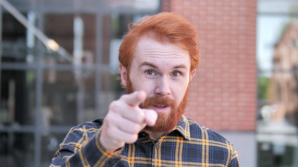 Redhead Beard Young Man Pointing with Finger Outdoor