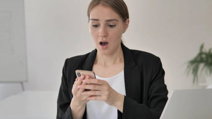Young Businesswoman Upset by Loss on Smartphone