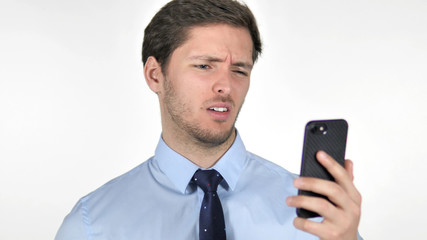 Young Businessman Reacting to Loss on Smartphone on White Background