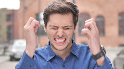 Young Man Upset by Loss while Working in Office