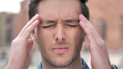 Fototapeta premium Outdoor Close up of Young Man with Headache