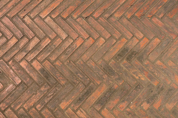 Brick wall and floor, in zigzag pattern, abstract and background, in orange brown color.
