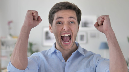 Handsome Young Man Celebrating Success  Gesture in Office