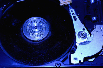 Closeup hard disk detail on blue background.